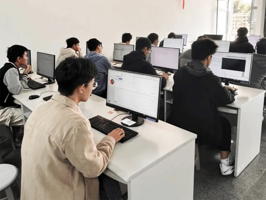 Students programming in the classroom while learning to develop games with AI